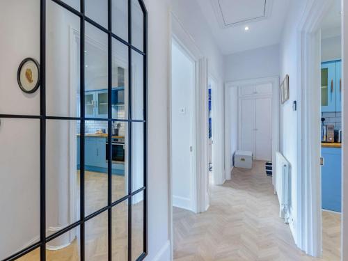 a hallway with a glass wall in a house at 2 bed property in Rye 87139 in Rye