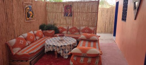 a living room with a couch and a table at Natural Farming in Ti nʼAmara