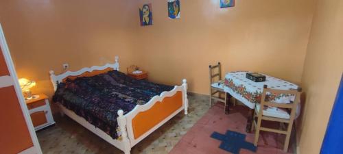 a bedroom with a bed and a table and a ladder at Natural Farming in Ti nʼAmara