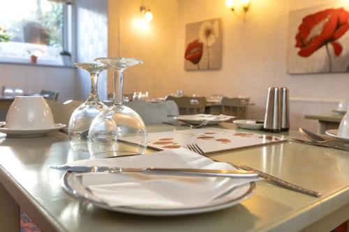 a table with plates and wine glasses on it at The Fairmile in Lytham St Annes