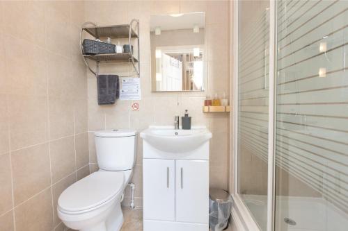 a bathroom with a toilet and a sink and a shower at The Fairmile in Lytham St Annes
