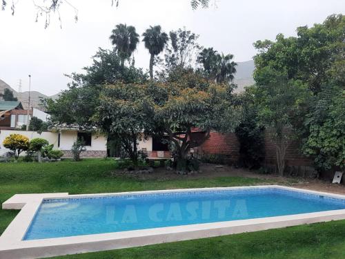a swimming pool in the yard of a house at La Casita de Cieneguilla in Cieneguilla