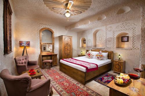 a bedroom with a bed and a table and chairs at Simera in Cappadocia - Special Class - Best View Rooftop in Uchisar