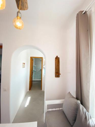 a hallway with white walls and a couch in a room at Villas Scirocco in Fira