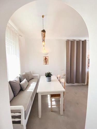 a living room with a couch and a table at Villas Scirocco in Fira