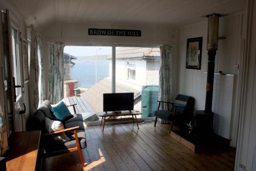 a living room with a view of the ocean at The Little Beach House, Sennen Cove in Sennen