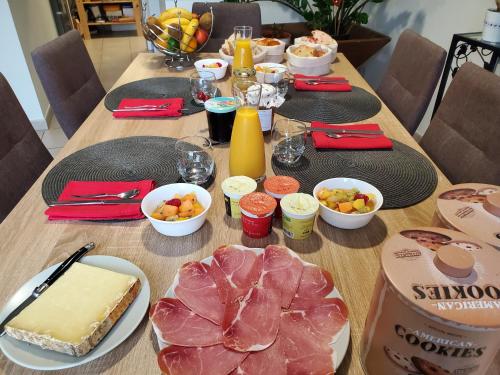 a wooden table with food on top of it at Chambres et Table d'hotes du calvaire in Villefranche-de-Rouergue