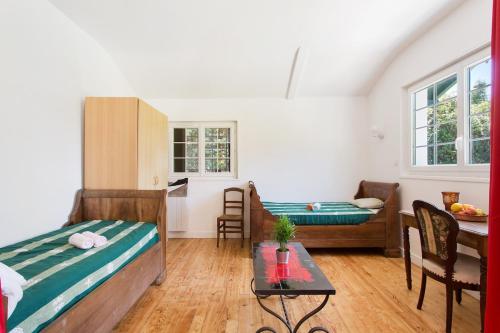 a room with two beds and a table in it at Bidart - Uhabia plage - Maison familiale in Bidart