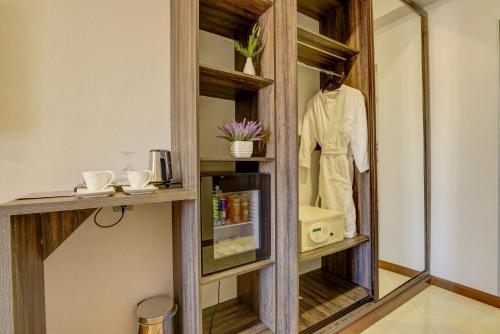 a dressing room with a mirror and a mannequin at Hotel Lulu in Bishkek