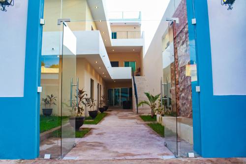a hallway of an apartment building with glass doors at Hotel Zibahun in Valladolid