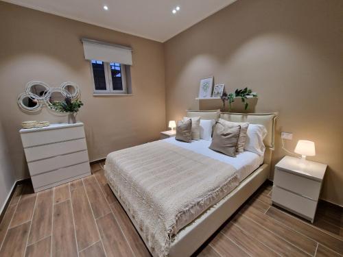 a bedroom with a bed and two dressers and mirrors at Piccole Donne in Naples