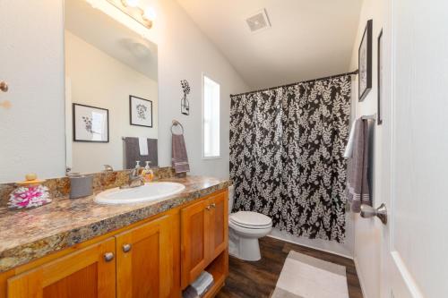 a bathroom with a sink and a toilet at Cute and Cozy 3 Bed 2 Bath Home in North Spokane in Spokane
