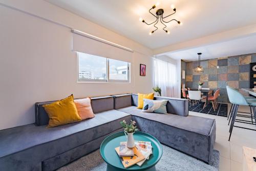 a living room with a couch and a table at NEW Cheerful Family Friendly Roma Norte Condo in Mexico City