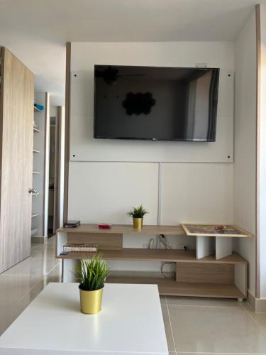 a living room with a tv on a wall at Apto de lujo. Ricaurte-Girardot in Ricaurte