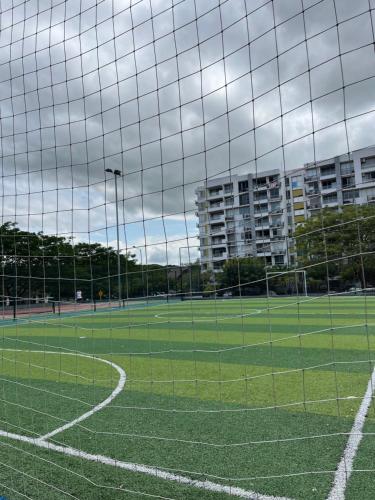 a soccer field with a goal with buildings in the background at Apto de lujo. Ricaurte-Girardot in Ricaurte