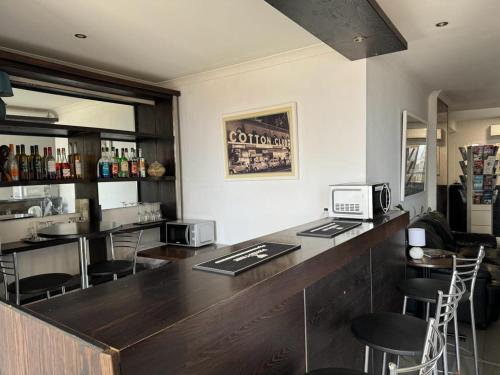 a bar in a restaurant with bar stools at Roma Hotel in Sliema