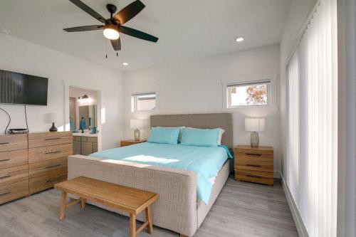 a bedroom with a bed and a ceiling fan at Bright Cotter Vacation Rental with White River Views in Cotter
