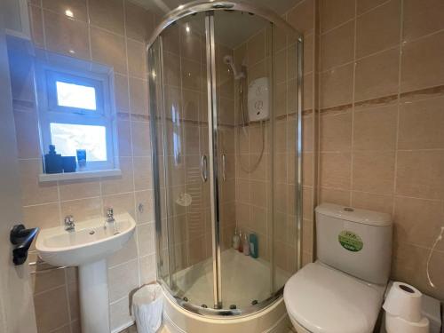 a bathroom with a shower and a toilet and a sink at Modern Spacious 5 Bed House in Newcastle in Newcastle upon Tyne