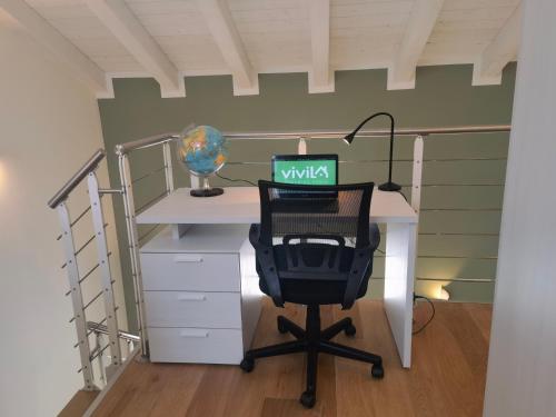 an office with a desk with a laptop computer on it at Vivila - Al Lucernario in Cernusco sul Naviglio