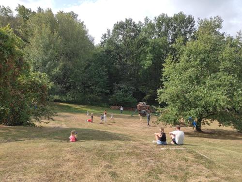 a group of people sitting on the grass in a park at Pagel in Catus