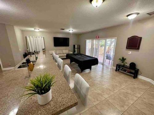 a large living room with a pool table and couch at Spacious and cozy house in Miami in Tamiami