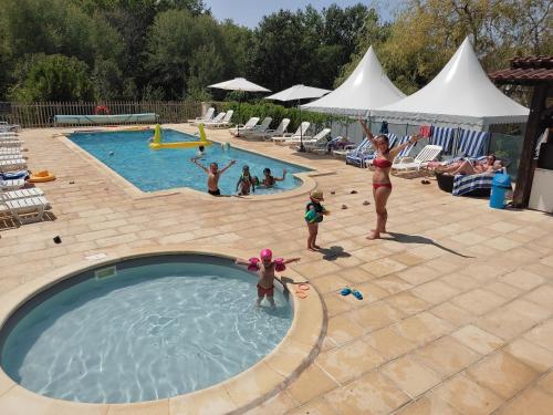 a group of people playing in a swimming pool at Pagel in Catus