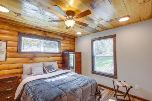 a bedroom with a bed and a ceiling fan at Pet-Friendly Chattanooga Cabin with Hot Tub and Kayaks in Chattanooga