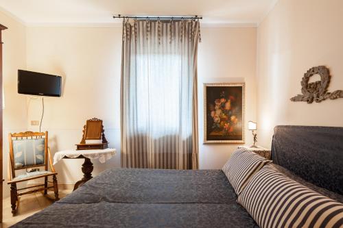 Llit o llits en una habitació de Francesco Redi Camere