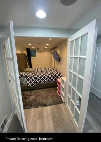 a small bedroom with a bed in a room at Cozy Basement Apartment in Brampton