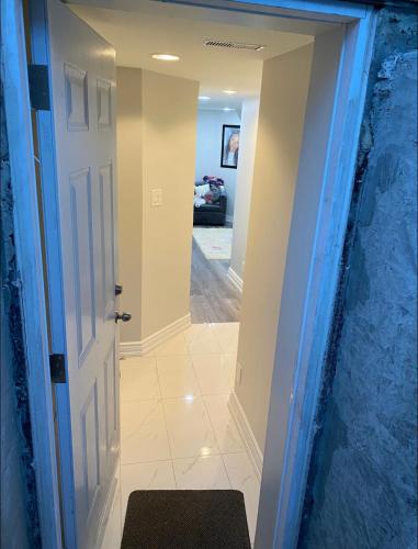 a hallway leading into a house with a door at Cozy Basement Apartment in Brampton