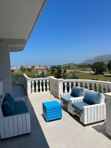 a patio with couches and chairs on a balcony at Villa RESA - Intero allogio in Orikum
