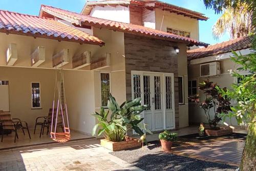 a house with a porch and a patio at Aconchego perto das Cataratas. in Foz do Iguaçu