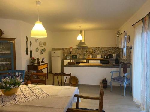 a kitchen and dining room with a table and chairs at Ferroa Guest House in Cano