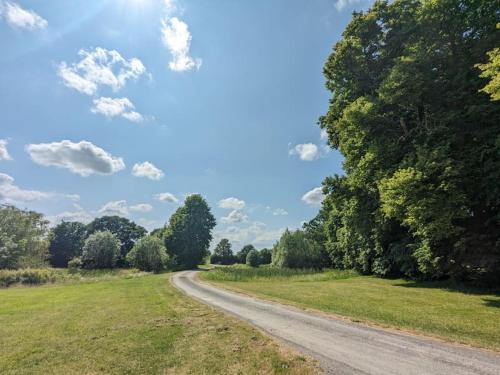a dirt road in a field with trees at The Barn at Linwood Hall Farm in Martin