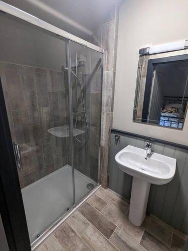 a bathroom with a shower and a sink at The Barn at Linwood Hall Farm in Martin