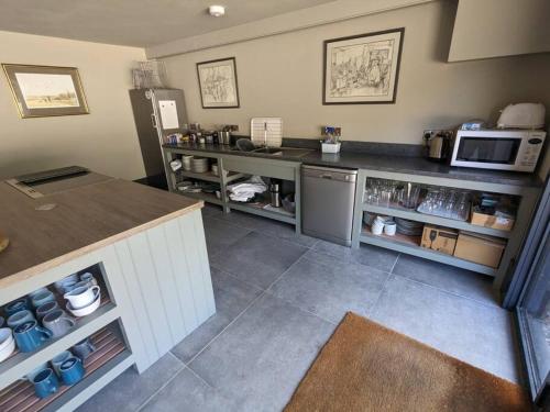 a kitchen with a counter and a microwave at The Barn at Linwood Hall Farm in Martin