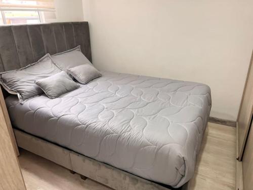 1 cama con 2 almohadas en una habitación en Apartamento Barrio La Felicidad, en Bogotá