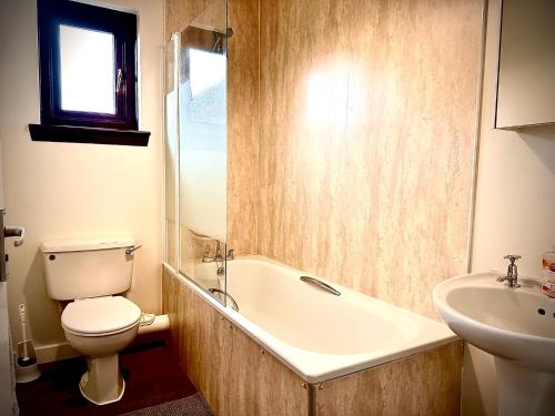 a bathroom with a tub and a toilet and a sink at Grampian Serviced Apartments - Ladyhill Neuk - 1 Bedroom Apartment in Elgin