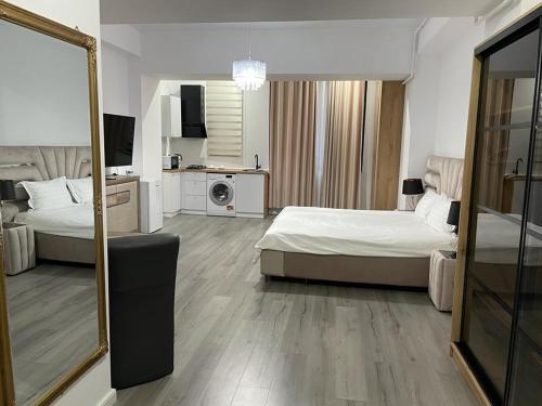 a hotel room with two beds and a mirror at Ap Nou Rezidential Faleza in Galaţi