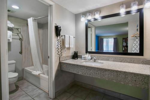 a bathroom with a sink and a toilet and a mirror at Motel 6 Willcox, AZ in Willcox