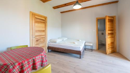 a bedroom with a bed and a door to a bathroom at Dom Przy Puszczy Noteckiej in Skrzynice