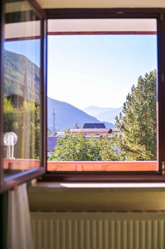 a window with a view of a mountain view at Ferienhotel Alber in Mallnitz