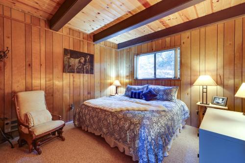 a bedroom with a bed and a chair and a window at 3 Mi to Big Trees State Park Cabin with Deck in Arnold