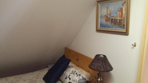 a bedroom with a bed and a picture on the wall at The Cedars Bed and Breakfast in Centurion