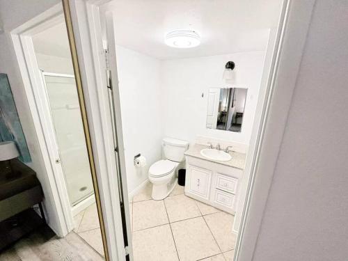 a white bathroom with a toilet and a sink at ৎ୭ Valley Village Privacy Lux ৎ୭ in Los Angeles
