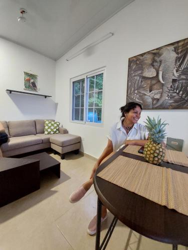 a man sitting at a table in a living room at Paradise Venao - Cañas in Cañas
