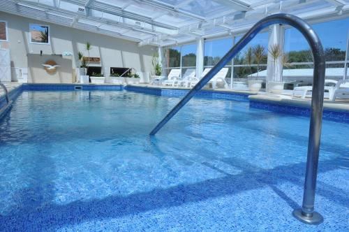 a swimming pool with a water slide in a hotel at Carilo Soleil By HS in Carilo