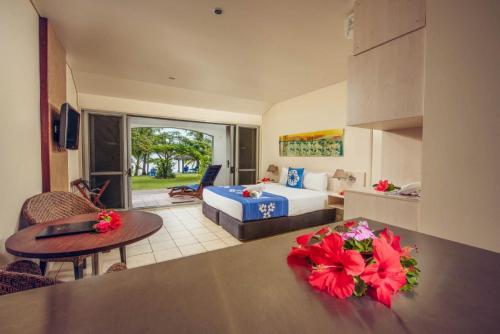 a hotel room with a bed and a living room at Sunset Resort in Rarotonga