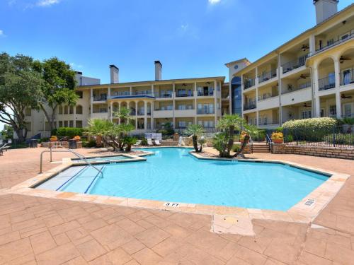 a large swimming pool in front of a building at ILT 3122 Lakeside Oasis in Lago Vista