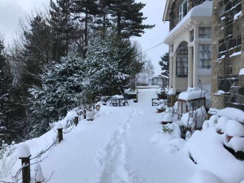 a yard covered in snow next to a building at Dilkusha, Peebles in Peebles